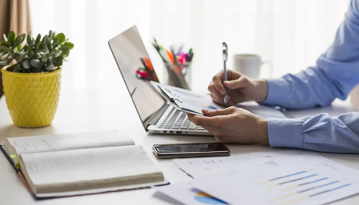 man-writing-documents-office